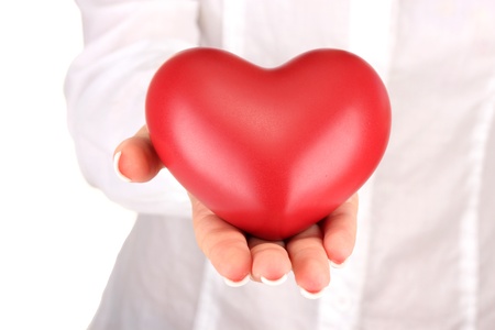 Red heart in woman's hand, on white background close-upの写真素材