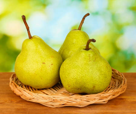 Ripe pears on colorful green backgroundの写真素材