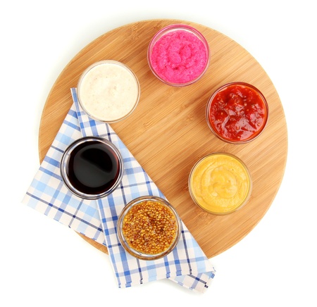 various sauces on chopping board isolated on whiteの写真素材