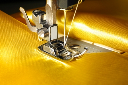 Sewing machine with gold cloth closeupの写真素材