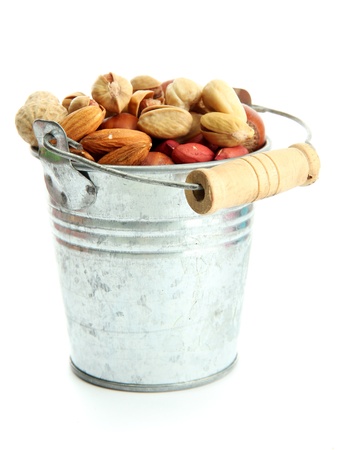 assortment of tasty nuts in pail, isolated on whiteの写真素材