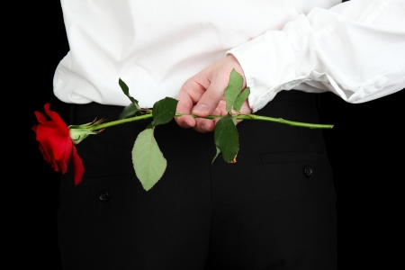 man holding rose close-upの写真素材