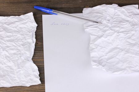 Creation of composition and crumpled sheets on wooden tableの写真素材