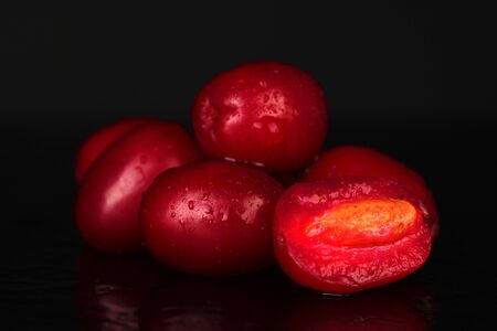 fresh cornel berries isolated on blackの写真素材