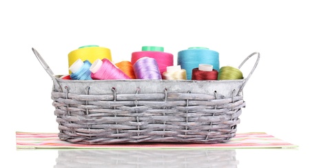 Bright threads in basket isolated on whiteの写真素材