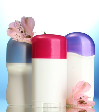 deodorants with flowers on blue backgroundの写真素材
