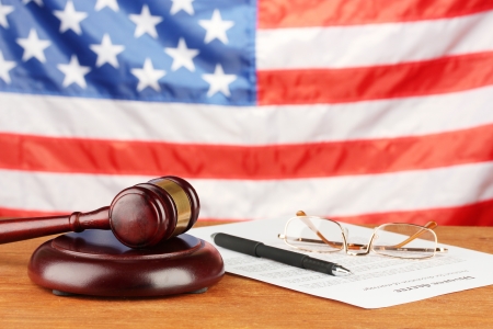 Divorce decree and wooden gavel on american flag backgroundの写真素材