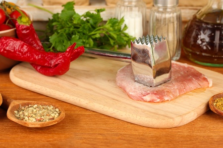 composition of raw meat, vegetables and spices on wooden table close-up