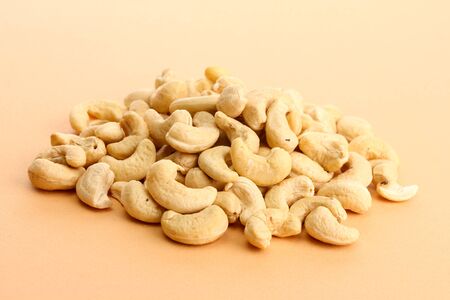 tasty cashews nuts, on beige backgroundの写真素材