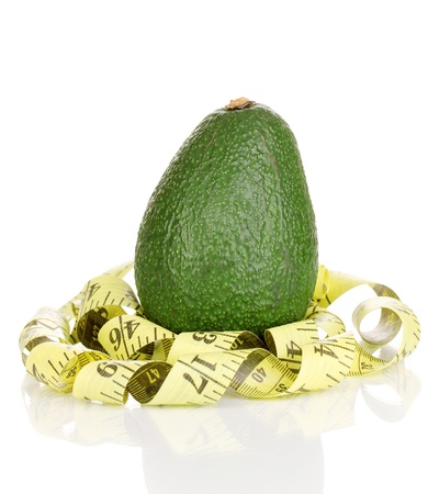 avocado with measuring tape isolated on whiteの写真素材