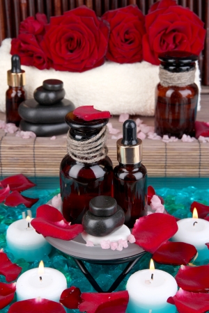 Beautiful spa setting on pool on bamboo background close-upの写真素材