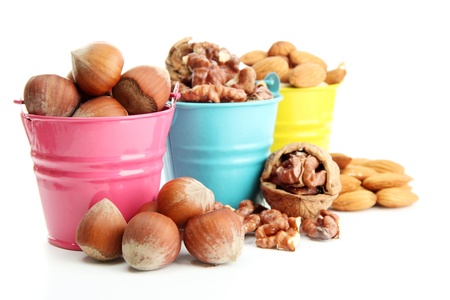 assortment of tasty nuts in pails, isolated on white