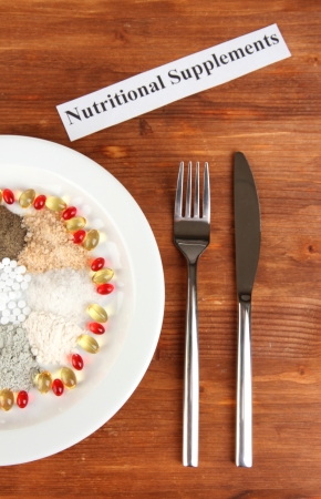 Nutritional supplements on wooden background close-upの写真素材