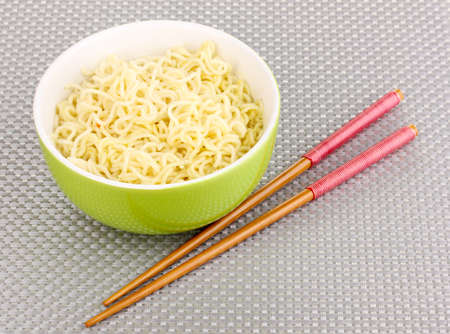 asian noodles in bowl on grey matの写真素材