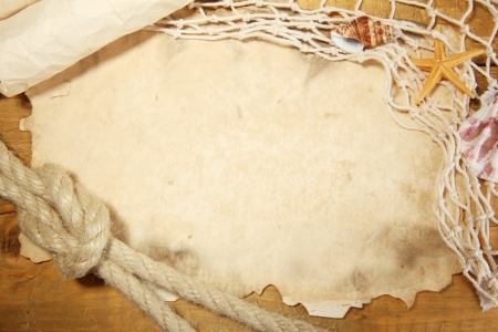 old paper, fishing net and rope on wooden tableの写真素材