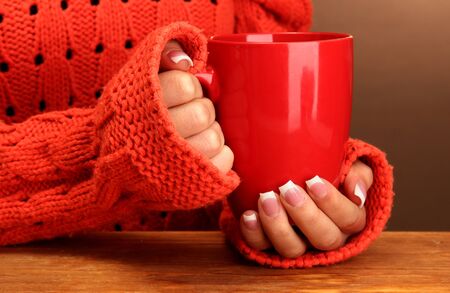 hands holding mug of hot drink, close-upの写真素材