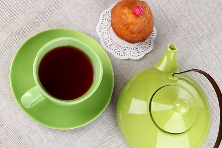 Top view of cup of tea and teapot on tableclothsの写真素材