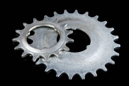 Metal cogwheels on black backgroundの写真素材