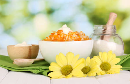 Useful pumpkin porridge in white plate on wooden table on natural backgroundの写真素材