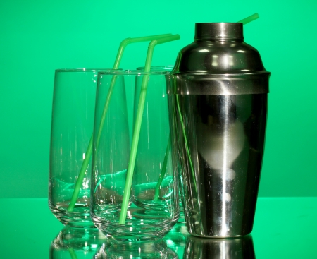 Cocktail shaker and glasses on color backgroundの写真素材