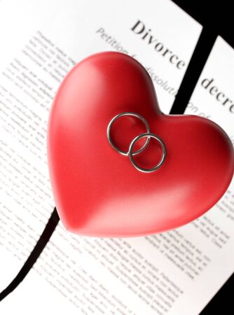 red heart with torn Divorce decree document, on black background close-upの写真素材