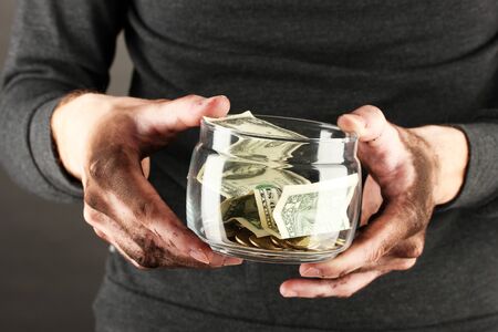 homeless holds bank with money, close-upの写真素材