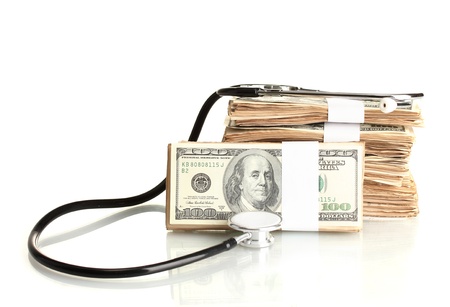 Healthcare cost concept: stethoscope and dollars isolated on whiteの写真素材