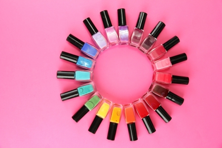 Group of bright nail polishes, on pink backgroundの写真素材