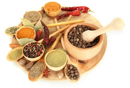 wooden mortar, bowls and spoons with spices isolated on whiteの写真素材