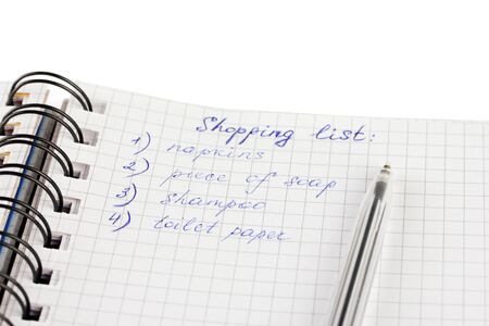 shopping list in a notebook on white background close-upの写真素材
