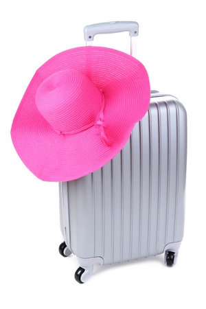 Silver suitcase with woman's hat  isolated on whiteの写真素材