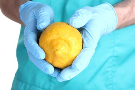 A scientist holds a genetically modified lemonの写真素材