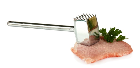piece of pork with a meat hammer isolated on whiteの写真素材