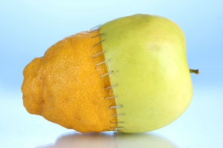 Genetically modified fruits on blue backgroundの写真素材