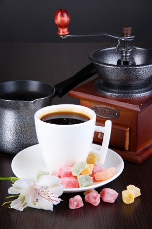 White cup of Turkish coffee with rahat delight and coffee mill on wooden tableの写真素材