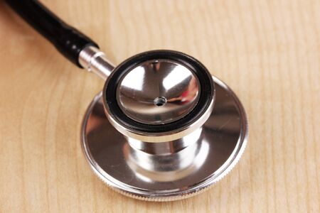 Stethoscope close-up on white wooden tableの写真素材