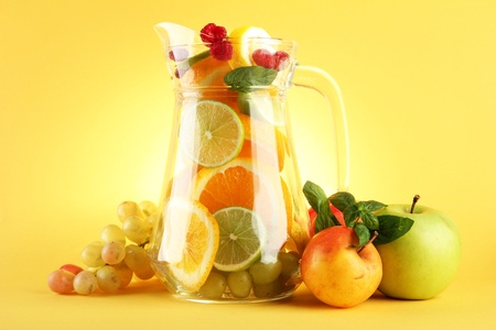 transparent jar with citrus fruits and raspberries, isolated on whiteの写真素材