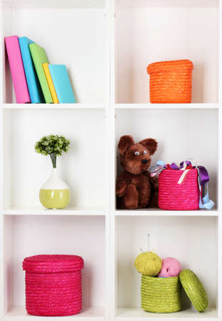 Color wicker boxes on cabinet shelvesの写真素材