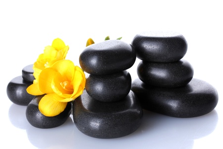 Spa stones and yellow flower isolated on whiteの写真素材