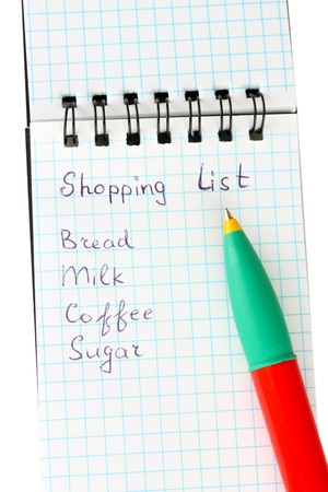 shopping list in a notebook on white background close-upの写真素材