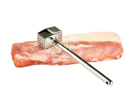 raw pork with a meat hammer isolated on whiteの写真素材