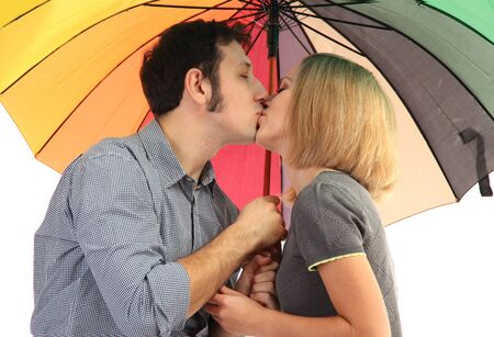 Loving couple with umbrella isolated on whiteの写真素材