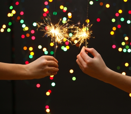 beautiful sparklers in woman hands on garland background
の写真素材