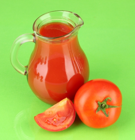 Full jug of tomato juice, on color backgroundの写真素材