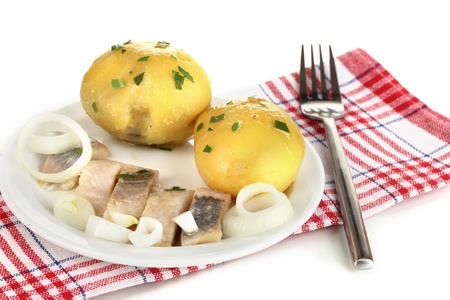 Dish of herring and potatoes on plate isolated on whiteの写真素材