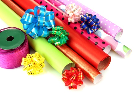 Rolls of Christmas wrapping paper with ribbons, bows isolated on whiteの写真素材