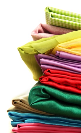 heap of cloth fabrics on wooden tableの写真素材