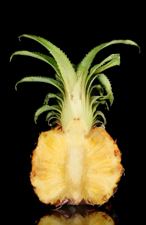 Half of ripe pineapple isolated on blackの写真素材