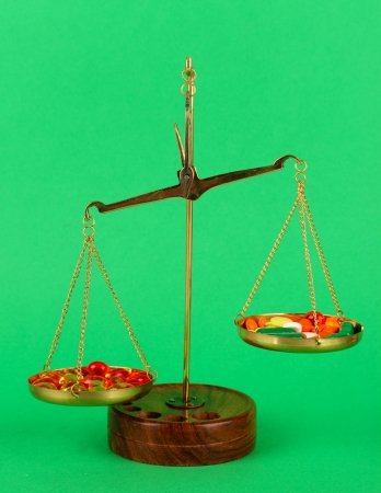 Classic scales with color pills on color backgroundの写真素材