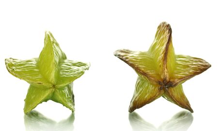 Two ripe carambolas isolated on whiteの写真素材